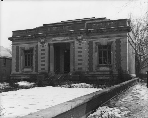 Exterior view of the front entrance of the Case Memorial building. Snow is on the ground.