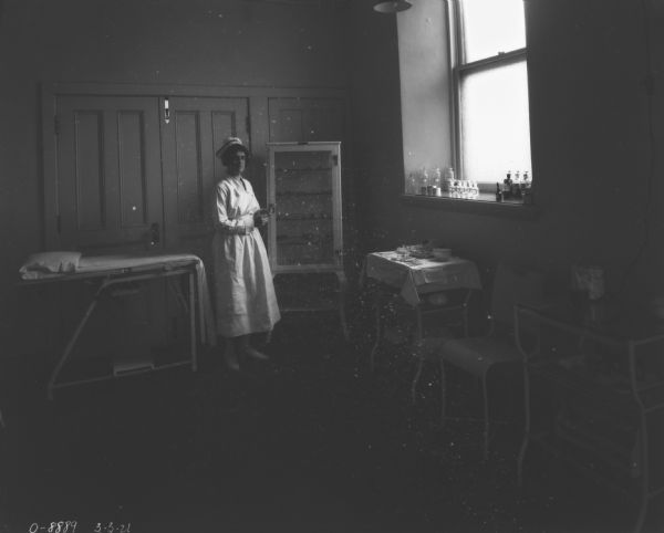 Nurse standing in infirmary.
