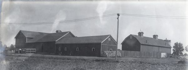 View from across road of the Winnebago County Asylum farm buildings, including a large barn.