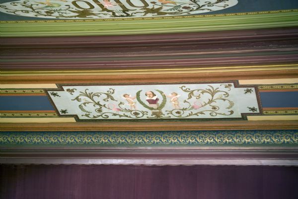 Close-up of Frank Waldo decorative motif on the proscenium arch in the Grand Opera House. Features a portrait of William Shakespeare flanked by cupids and flamingos.