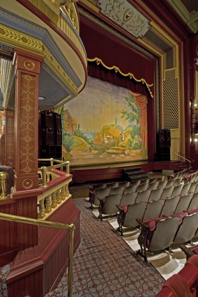 View of stage and box in Grand Opera House featuring a recreated painted curtain.