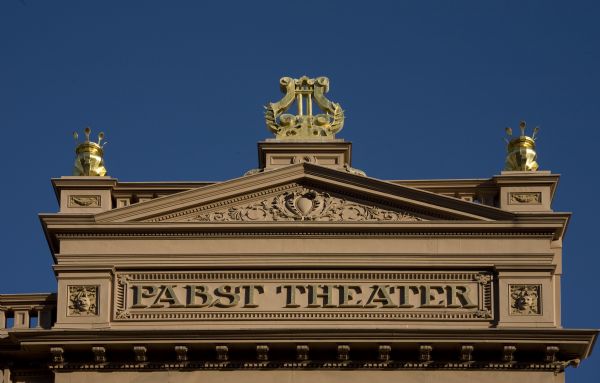 Exterior view of Pabst Theater sign adorned with gilded harp.
