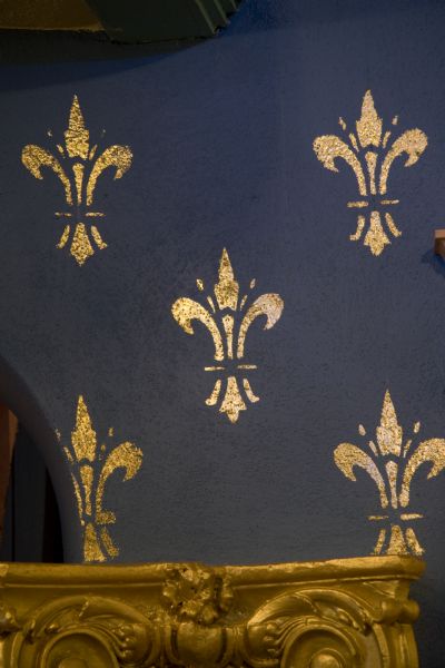 Close-up of gilded fleur-de-lis pattern on proscenium arch of Stoughton Opera House.