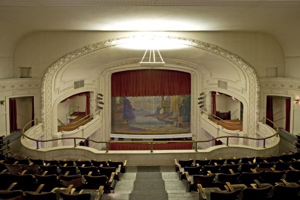View of Mineral Point Opera House auditorium and stage from rear balcony including painted stage curtain.