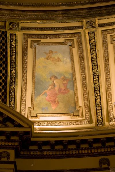 Close-up of plasterwork and a painted wall panel in the Al. Ringling Theatre.  Painting features Venus and cupids lounging in the clouds.