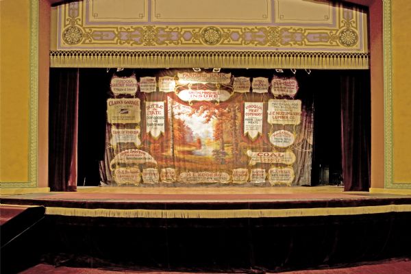 View of stage and original painted act curtain in the Temple Theatre.