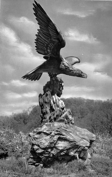 A bronze eagle sculpture perched on a rock at Elm Valley Farm.