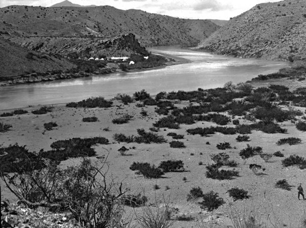 The site of Elephant Butte Dam prior to construction of the dam showing desert hills and the Rio Grande River. Construction was completed in 1916, and at the time it was the second largest irrigation dam ever built. The name refers to a volcanic core formation in the shape of an elephant which is now an island in the lake.