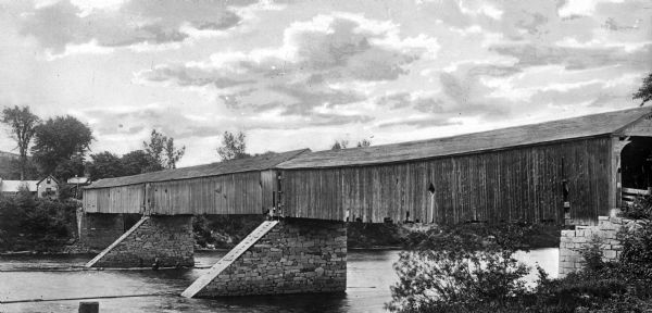 A view of Old Cheshire Covered Bridge over the Conneticut River between Charlestown, New Hampshire, and Springfield, Vermont.