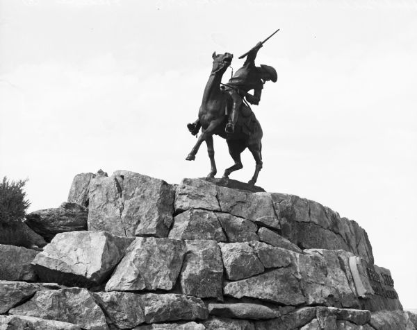 Gertrude Vanderbilt Whitney's sculpture entitled "Buffalo Bill - The Scout," which commemorates William Frederick "Buffalo Bill" Cody.  The bronze sculpture of a man on horseback brandishing a rifle perches atop a pile of rocks.
