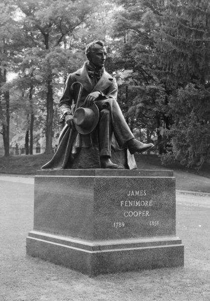 Dedicated on August 31, 1940, the Victor Salvatore bronze sculpture of American author James Fenimore Cooper sits in Cooper Park.  The statue depicts the author seated, holding a hat and a cane.