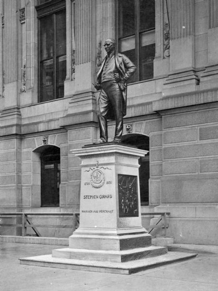 Bronze statue honoring the banker and philanthropist Stephen Girard that stands next to the City Hall.  A small portion of its facade forms the background of the picture.