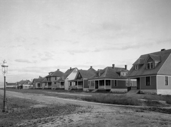 A view of residences, with unpaved roads.