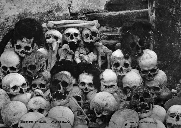 A view of a pile of human skulls and bones in Manila in the Philippine Isles.