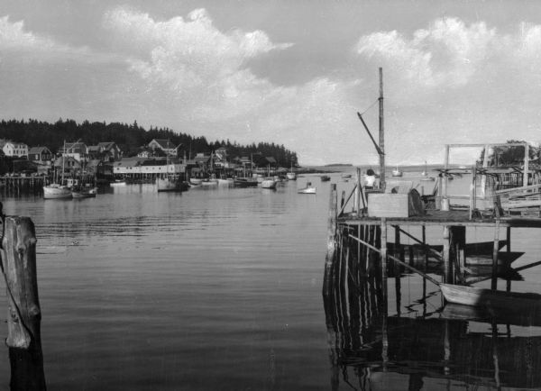 A view of boats in the harbor of a village in Maine.