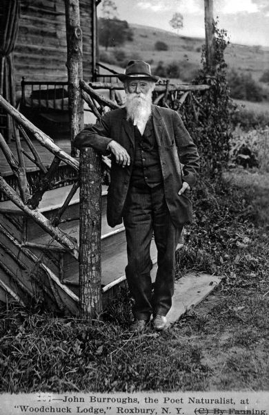 John Burroughs (4/3/1837 – 3/29/1921), an American naturalist and essayist important in the evolution of the U.S. conservation movement, standing on the porch of Woodchuck Lodge, near Roxbury, New York, his summer residence for the last two decades of his life.