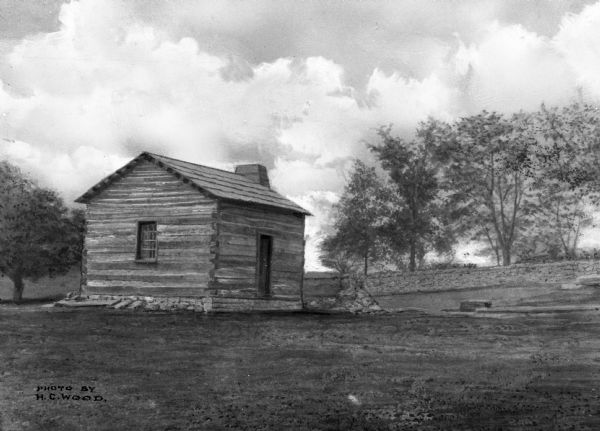 A view of what might be one of the Illinois cabins associated with Abraham Lincoln or his family. Text in lower left corner reads: "Photo by HC Wood."