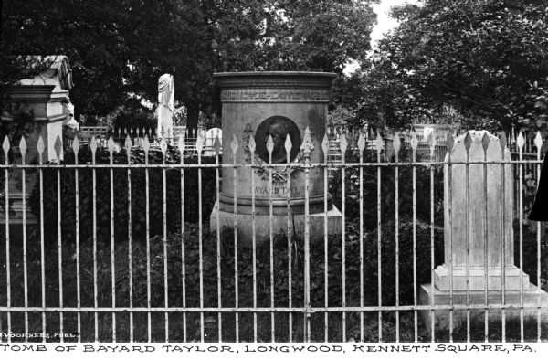 View through fence of the tomb of American poet, literary critic, translator, and travel author, Bayard Taylor (1/11/1825 – 12/19/1878). Caption reads: "Tomb of Bayard Taylor, Longwood, Kennett Square, PA.