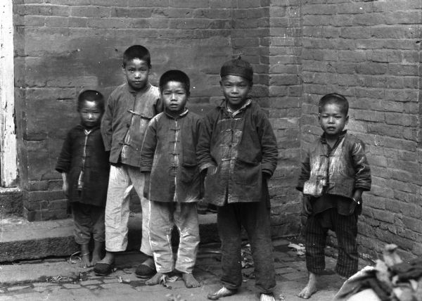 Five young boys waiting to enter Maryknoll School in China.