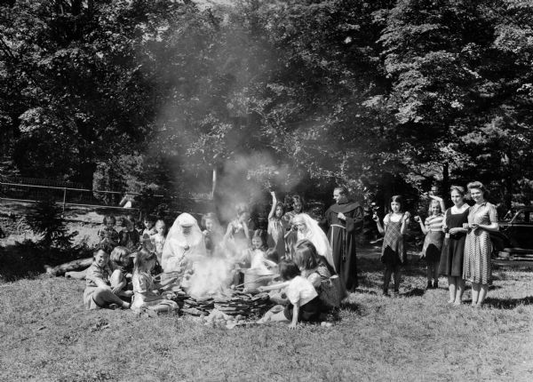 Campers cook apples around a campfire at St. Joseph's Burghardy, a small convalescent care center for children, with the Franciscan Missionaries of Mary.