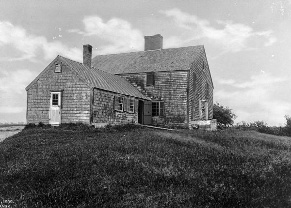 Exterior of the John Alden (1599 – 9/12/1687) house, a late 17th century or early 18th century structure, which exhibits its typical Plymouth Colony style. Alden, a ship-carpenter by trade and a cooper for The Mayflower, is said to be the first person to set foot on Plymouth Rock in 1620.