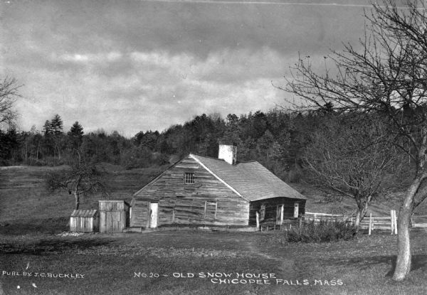 A view of the "Old Snow House," a low wooden house in an isolated setting. Caption reads: "Old Snow House, Chicopee Falls, Mass."