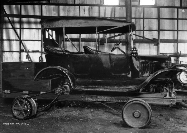 Ford touring car altered and fitted with flanged wheels to run on track at Berkeley Machine Works Inc. The plate on the side of the car reads: "Motor Cars Berkley Mch Wks Norfold, VA."