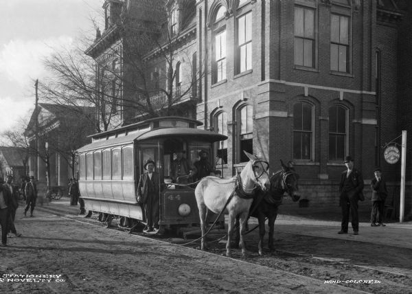 A trolley pulled by two horses through downtown Covington, Georgia, with the Newton County Court House in the background.
