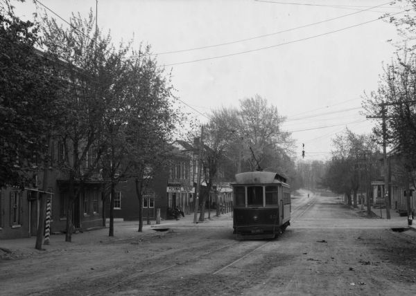 View down street towards a trolley car which began running in 1933.
