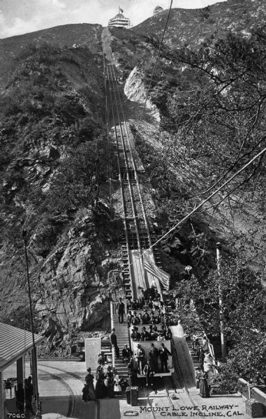 The cable car on Mount Lowe Railway, existing from 1893-1938, climbing a steep incline in California. Mount Lowe is known for being the only scenic mountain, electric traction railroad in the United States. Caption reads: "Mount Lowe Railway — Cable Incline, Cal."