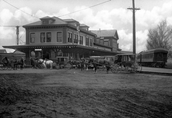 Carriages waiting at the Maine Central Railroad Station, chartered in 1856 and becoming operational in 1862. The Maine Central route was also known as "The Pine Tree Route."