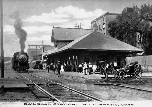 Willimantic Railroad Station was built for the Air Line route between Boston and New York City. The New Haven, Middletown, and Willimantic Railroad Company was formed in 1867, but soon went bankrupt, merging into the Boston and New York Air Line Railroad in 1875. Caption reads: "Railroad Station, Willimantic, Conn."