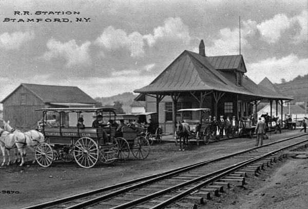 The Stamford Railroad Station allowed tourists to visit the popular stop of Stamford, home of the Stamford Country Club. Carriages await the next train outside the station. Caption reads: "R. R. Station, Stamford, N.Y."