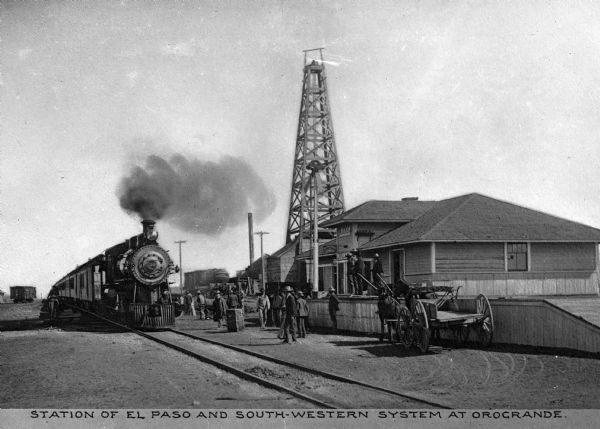 Originally known as Arizona & Southeastern Railroad, the El Paso and South-Western Railway was built in 1888.  The Jarilla Junction was renamed 'Orogrande,' or 'Big Gold,' after the discovery of gold in 1905. Caption reads: "Station of El Paso and South-Western System at Orogrande."