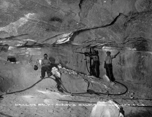 Avery Island is home to the oldest salt mine in North America.  A view of men working in the mines is shown. Caption reads: "Drilling Salt - Avery's Salt Mine, New Iberia, LA."