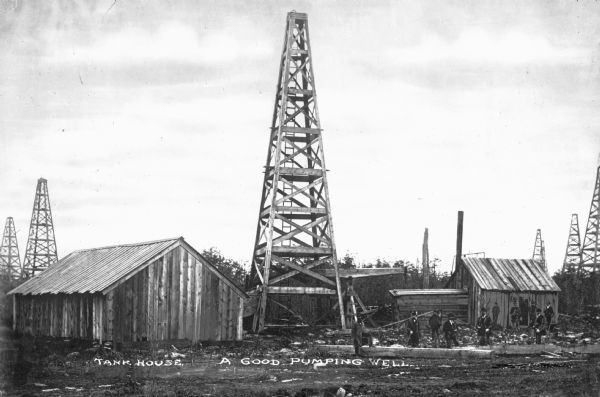 This view of an oil field, possibly in Titusville, Pennsylvania, shows a "good pumping well." Caption reads: "Tank House. A Good Pumping Well."