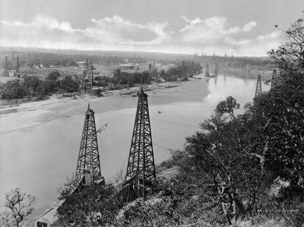An oil scene on the Cimarron River, 100 miles from Tulsa, a city that had earned the title "Oil Capital of the World" and whose population grew to 72,000 by 1920.