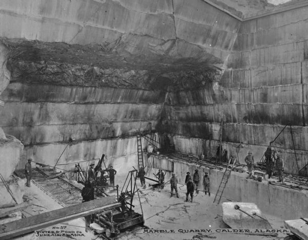 A quarry of Alaska Marble Company at Calder, with men at work.  Photograph published by Winter and Pond Company. Caption reads: "Marble Quarry, Calder, Alaska."