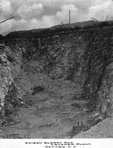 Edison Quarry was opened in the largest outcropping area of Precambrian marble south of the Franklin - Sterling Hill area. Edison's crusher is said to be able to handle 10-ton rocks. Caption reads: "Edison Quarry and Crusher Plant, Oxford, N.J."