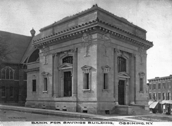 Ionic columns frame the doorways of the Bank for Savings, a stone building constructed in 1906 in the Beaux-Arts style by Lansing C. Holden. Caption reads: "Bank for Savings Building, Ossining, N.Y."