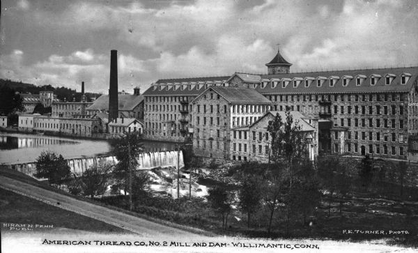 Mill Number Two of the American Thread Company. The English Sewing Company purchased the Willimantic Linen Company England mills in 1898 and formed the American Thread Company. The company reached its height in the early 20th century, and became the largest factory in Connecticut and the largest thread mill in North America. Caption reads: "American Thread Co., No. 2 Mill and Dam - Willimantic, Conn."
