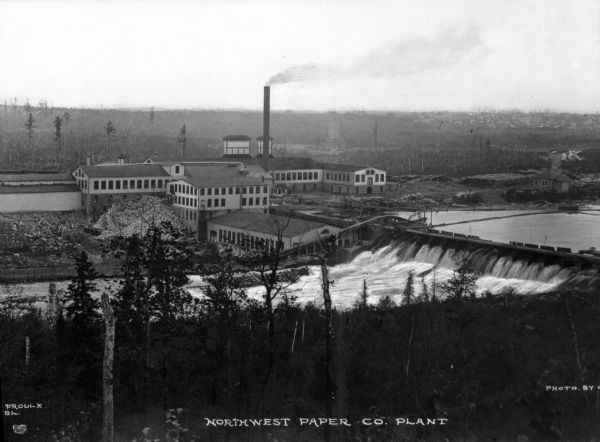 An exterior view of the Northwest Paper Company. It was founded in 1898 and manufactured high quality printing, writing, and converting paper.  The Cloquet plant consisted of four high speed paper machines and two chemical pulp mills. Caption reads: "Northwest Paper Co. Plant."