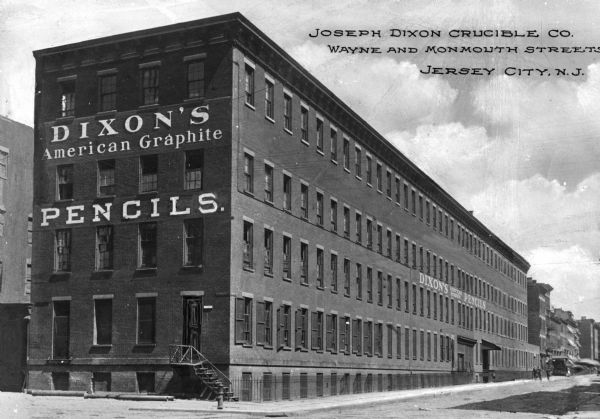 Exterior view of the Joseph Dixon Crucible Company, manufacturer of American Graphite Pencils. They introduced the first graphite pencil in 1829. Caption reads: "Joseph Dixon Curcible Co. Wayne and Monmouth Street. Jersey City, N.J."