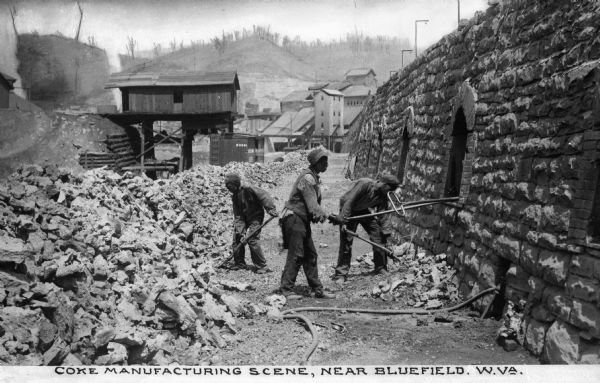 Men work with the coke ovens at the coal mine. Caption reads: "Coke Manufacturing Scene, Near Bluefield, West Virginia."