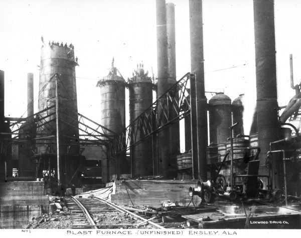 The industrial city of Ensley, Alabama constructed four 200-ton blast furnaces which were in operation by April, 1889, the largest such grouping in the world. Caption reads: "Blast Furnace (Unfinished) Ensley, ALA."