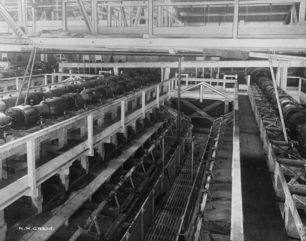 By 1919, the Washoe Reduction Works at Harding Mills could boast that its 585-foot smokestack was the tallest masonry structure in the world and that the smelter-refining complex constituted the world’s largest nonferrous processing plant. Inside the mill, flotation machines are shown that were used in the refining of copper.