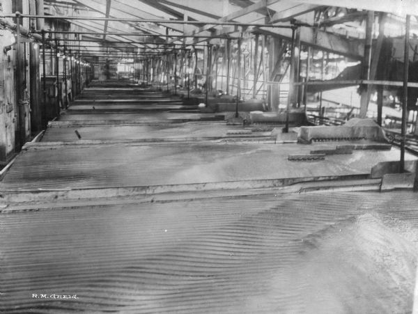Interior view of the Washoe Reduction Works. By 1919, the Washoe Reduction Works at Harding Mills could boast that its 585-foot smokestack was the tallest masonry structure in the world and that the smelter-refining complex constituted the world’s largest nonferrous processing plant.