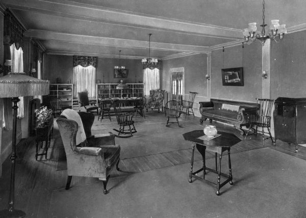 A view of chairs, bookshelves, and decorative lighting in the reception room of the National Federation of Business and Professional Women's Clubs, founded on July 16, 1919.