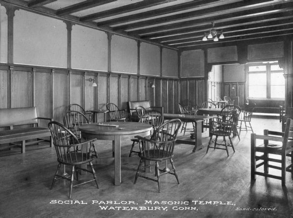 A view of chairs and tables in the social parlor of a Masonic Temple. Caption reads: "Social Parlor, Masonic Temple, Waterbury, Conn."