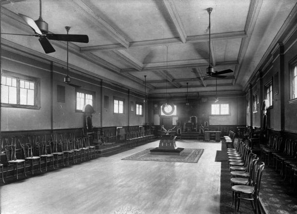 A view of antlers on a table and chairs lined up around the meeting hall of the Elks Club, founded in 1868.